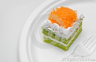 Piece of pandan cake with golden threads on top over plate Stock Photo