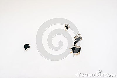 A piece of paper with jagged holes like bullet holes. Copy space Stock Photo