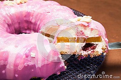 A piece or a portion of bright pink glazed cake Stock Photo