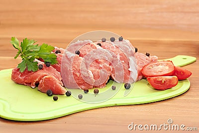 Piece of raw meat with spices and vegetables Stock Photo