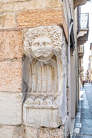 A piece of Roman sculpture on the corner of via valerio catullo and Corso Porta Borsari Editorial Stock Photo