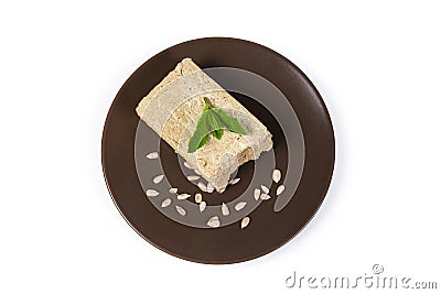 Piece of sunflower halva, sunflower seeds on dish, top view Stock Photo