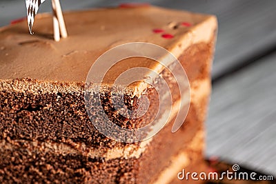 Piece of a tasty yummy chocolate cake with red racing stripes and flags Stock Photo