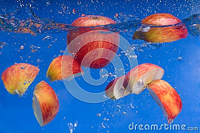 Pieces of apple floating in the water Stock Photo