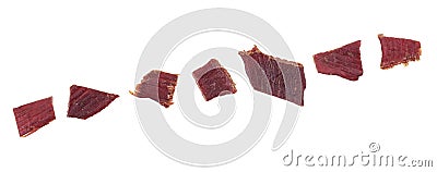 Pieces of beef jerky isolated on white background, top view. Cured meat. Dried meat Stock Photo