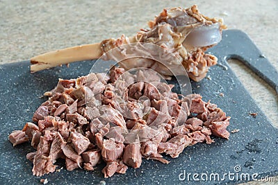 sliced boiled lamb meat with bone on a Board Stock Photo