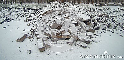 Pieces of broken asphalt covered with snow or ashes Stock Photo