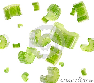 Pieces of celery fly and levitate in space. Isolated on white Stock Photo