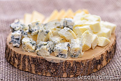 Pieces cheese on natural background. Natural cheeses slices, side view. Stock Photo