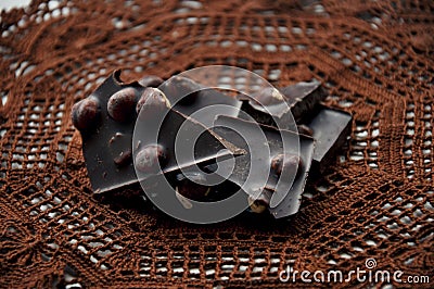 Pieces of chocolate on a crocheted napkin Stock Photo