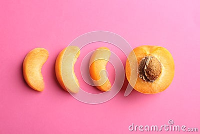 Pieces of delicious ripe sweet apricot on pink background Stock Photo