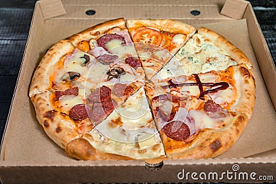 Pieces of different pizza in a box Stock Photo