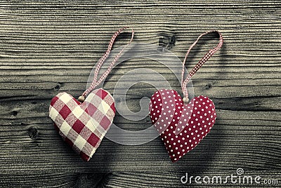 2 pieces of fabric hearts, polka dots , plaid, on wood background Stock Photo