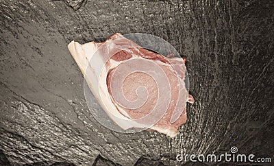 Pieces of fresh raw pork appetizing close-up on black stone background Stock Photo