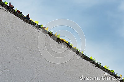 Pieces of glass put on a wall to avoid jumping Stock Photo