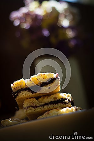 Pieces of grated cake with blueberry jam on plate Stock Photo