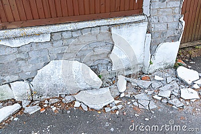 Concrete by old peeling fence with wooden details in village Stock Photo