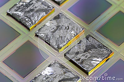 Pieces of polycrystalline silicon integrated on a polysilicon substrate with microchips Stock Photo