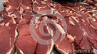 Pieces of raw beef meat on a market counter Stock Photo