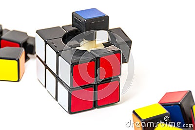 Pieces of Rubik`s Cube for problem solving on white background Editorial Stock Photo