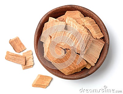 Pieces of sandalwood in the wooden bowl, isolated on white Stock Photo