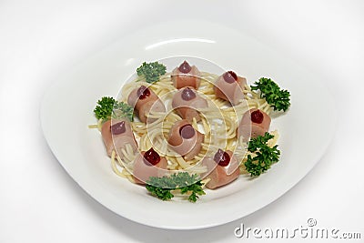 Pieces of sausages with spaghetti with ketchup and parsley Stock Photo