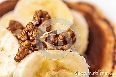 Pieces of walnuts and slices of bananas close up Stock Photo