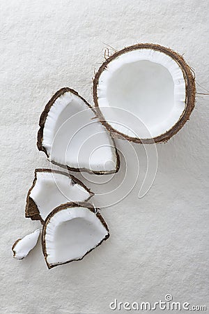 Pieces of a whole coconut cracked open Stock Photo
