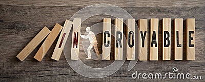 Pieces of wood with french word for incredible incroyable on wooden background Stock Photo