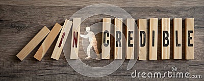 Pieces of wood with incredible and credible on wooden background Stock Photo