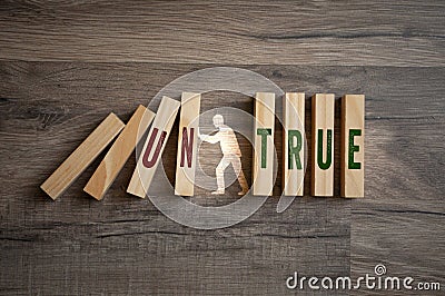 Pieces of wood with the words true and untrue on wooden background Stock Photo