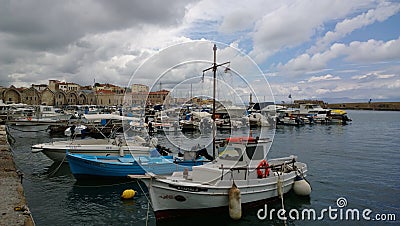 The pier in the city of Chania with lots of boats in cloudy weather Editorial Stock Photo