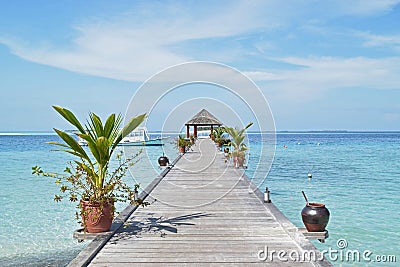 Pier leading to passenger boats at maldive Stock Photo