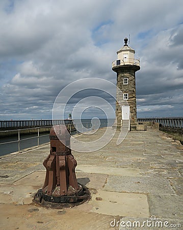 Pier of port of Whitby with lightouse Stock Photo