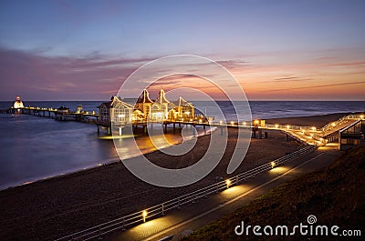 Pier in Sellin at purple dawn, Germany Stock Photo