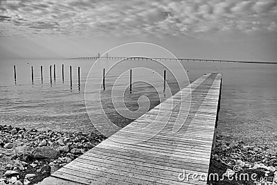 Pier on the shores of the Baltic Sea with visible Oresund bridge Stock Photo