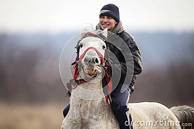 Man is bareback riding an adorned horse before an Epiphany celebration horse race Editorial Stock Photo