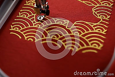 Pig embroidery framed by traditional shell pattern with gold on red fabric made by embroidery machine- chinese new year concept Stock Photo
