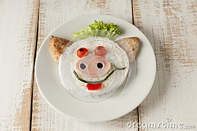 Pig from rice and cutlets on plate. Stock Photo