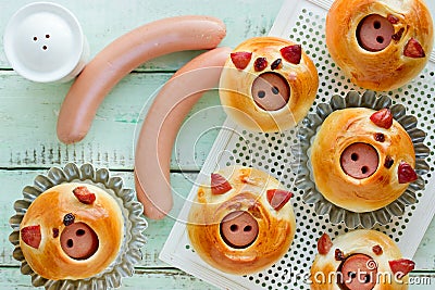 Piggies buns stuffed with sausage, homemade burger buns shaped funny pigs Stock Photo