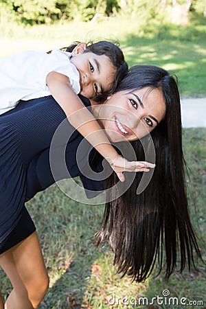 piggy back mother daughter beauty woman pretty girl child in summer lifestyle Stock Photo