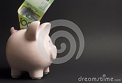 Piggy Bank with Australian hundred dollar note - with copy space Stock Photo