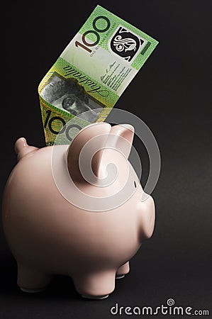 Piggy Bank with Australian hundred dollar note - vertical. Stock Photo