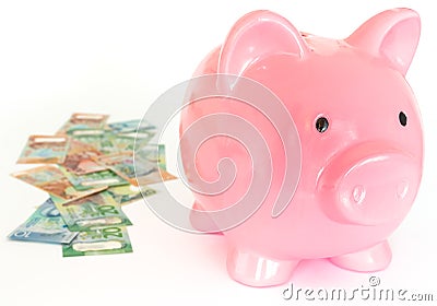Piggy bank and a bundle of dollars from New Zealand. Money savings concept / isolated of the white background Stock Photo
