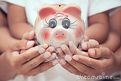 Piggy bank in child kid ,mother and father hands Stock Photo