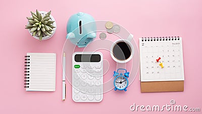 Piggy bank, coins, calculator, calendar, clock, notebook, pen Stock Photo