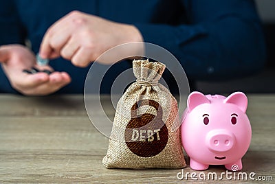 Piggy bank and debt burden. Refinancing and debt restructuring. Stock Photo