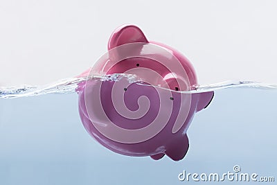 Piggy Bank Drowning In Water Stock Photo