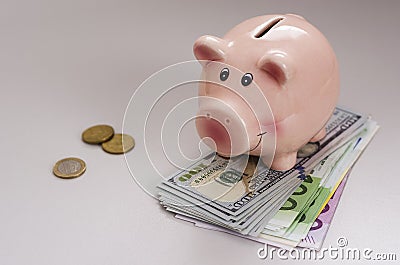 Piggy bank hundred dollar bills and euro notes of different denominations 3 Stock Photo