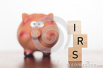 Piggy bank and IRS word Stock Photo